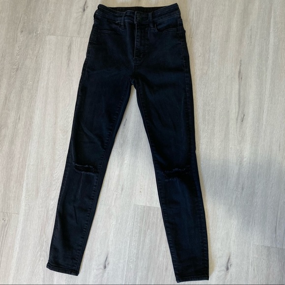 Black skinny jeans with rips at the knee